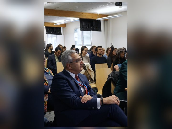 Prof. Georgi Chaltikyan is among delegates during a plenary discussion