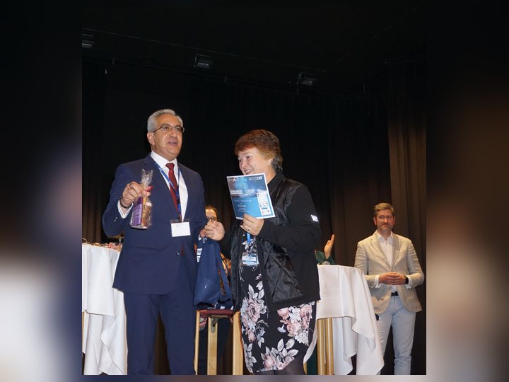 Prof. Georgi Chaltikyan is presenting an award during the closing ceremony