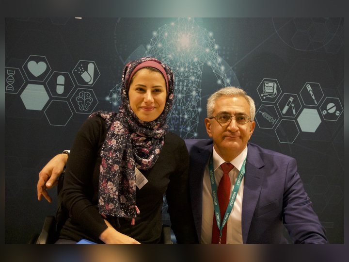 Prof. Georgi Chaltikyan joins a participant at the conference backdrop