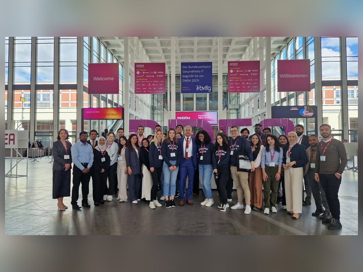 Prof. Georgi Chaltikyan with Master of Digital Health students in front of the DMEA letters at DMEA 2025